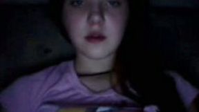 Amateur bruntte teen licks her lips in front of a webcam