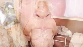 ”Old Woman squeezes her giant breasts with big nipples”