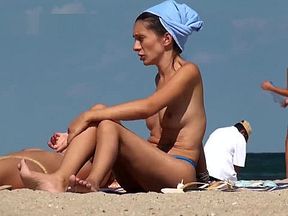 Teens topless on the beach showing firm young tits with hard nipples