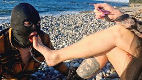 It's wonderful to listen to the sound of the sea while a slave sucks my toes. Dominatrix Nika and her foot slave.