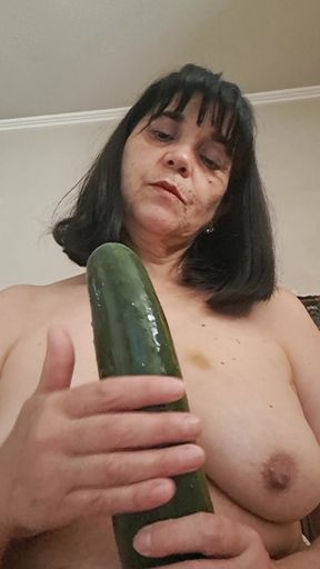 MILF playing with her tits and a cucumber, wetting it with her tongue