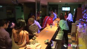 A party girl with tattooes gives blowjob to 2 guys in public